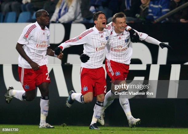 Ivica Olic is celebrated by his team mates Thiago Neves and Guy Demel of Hamburg after scoring the 1:1 goal during the Bundesliga match between VfL...