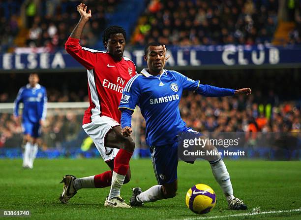 Ashley Cole of Chelsea is challenged by Alex Song of Arsenal during the Barclays Premier League match between Chelsea and Arsenal at Stamford Bridge...