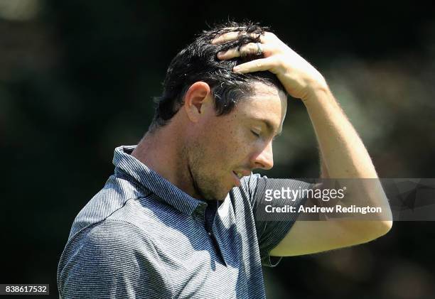 Rory McIlroy of Northern Ireland reacts after putting on the 18th green during round one of The Northern Trust at Glen Oaks Club on August 24, 2017...