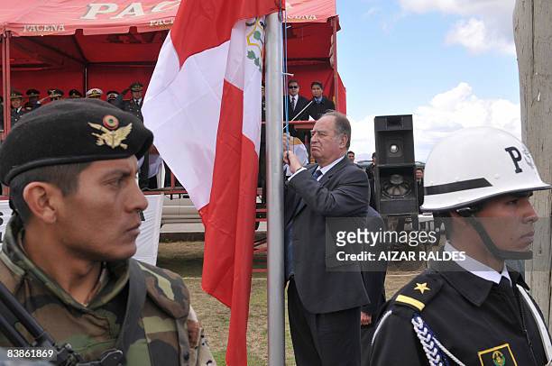 Peruvian Defence Minister Antero Flores Araoz hoists the Peruvian flag during a ceremony held on November 30, 2008 in Huarina, 75 km from La Paz, on...