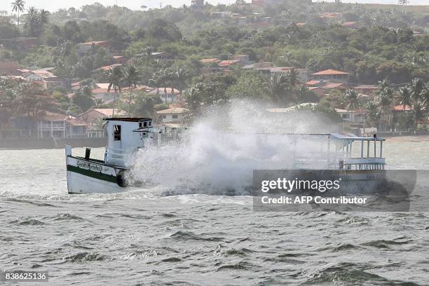 View of the boat Cavalo Marinho I that wrecked earlier today near the Itaparica island, Bahia State, Brazil, stranded in a coral reef, on August 24,...