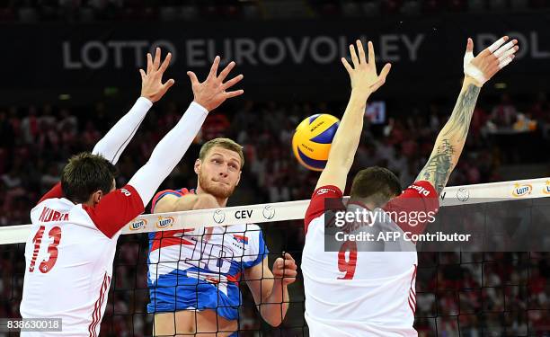 Serbia's Drazen Luburic spikes against Poland's Bartlomiej Lemanski and Michal Kubiak during the opening match between Poland and Serbia of the 2017...