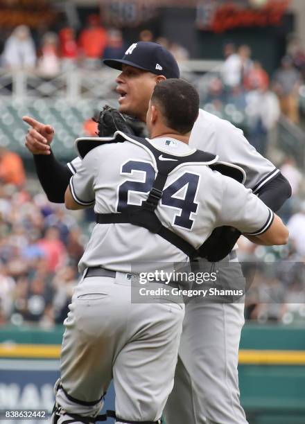 Dellin Betances of the New York Yankees is held back by Gary Sanchez as benches clear when he hit James McCann of the Detroit Tigers in the head...