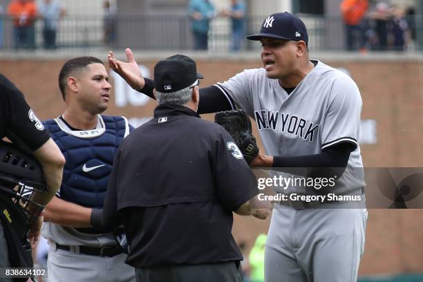 Dellin Betances of the New York Yankees reacts to being ejected from the game by umpire Dana DeMuth after hitting James McCann of the Detroit Tigers...