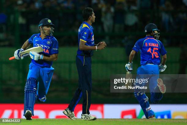 Indian cricketers M S Dhoni and Bhuvneshwar Kumar run between the wickets during the 2nd One Day International cricket match between Sri Lanka and...