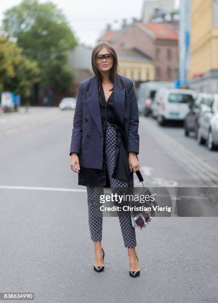 Darja Barannik wearing grey jacket, JW Anderson bag outside Vanessa Rudjord on August 24, 2017 in Oslo, Norway.
