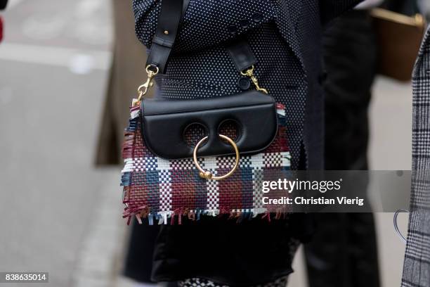 Guest wearing a plaid JW Anderson bag outside Vanessa Rudjord on August 24, 2017 in Oslo, Norway.