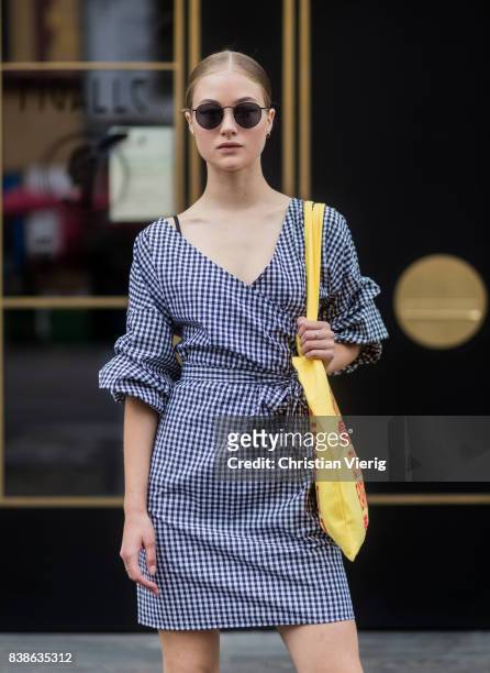 Model Lea Meyer wearing a plaid dress, yellow bag outside Vanessa Rudjord on August 24, 2017 in Oslo, Norway.