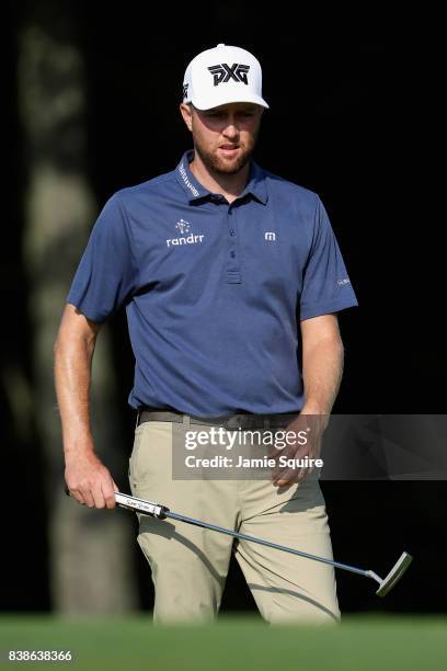 Chris Kirk of the United States prepares to play a shot on the 14th hole during round one of The Northern Trust at Glen Oaks Club on August 24, 2017...