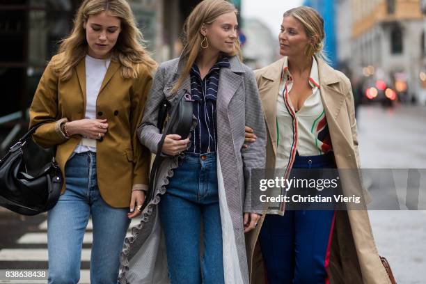 Guests wearing denim, trench coat, Loewe bag outside Bik Bok Runway Award on August 24, 2017 in Oslo, Norway.