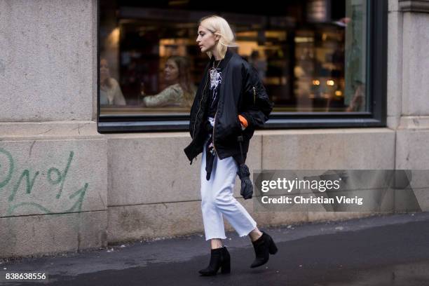 Guest wearing cropped white pants, bomber jacket outside Bik Bok Runway Award on August 24, 2017 in Oslo, Norway.