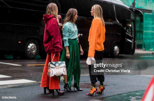 Guests wearing Balenciaga sock boots, Chanel bag, orange sweater with zipper on the back outside Bik Bok Runway Award on August 24, 2017 in Oslo,...