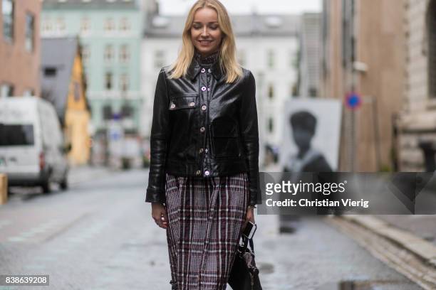 Hege Aurelie Badendyck wearing cropped pants, black Dior bag, sneakers, black leather jacket outside Bik Bok Runway Award on August 24, 2017 in Oslo,...