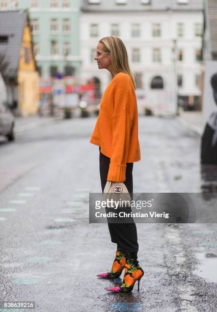 Celine Aagaard wearing an orange knit with zipper on the back, Balenciaga sock boots outside Bik Bok Runway Award on August 24, 2017 in Oslo, Norway.