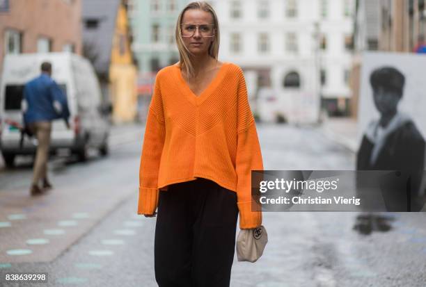 Celine Aagaard wearing an orange knit with zipper on the back outside Bik Bok Runway Award on August 24, 2017 in Oslo, Norway.