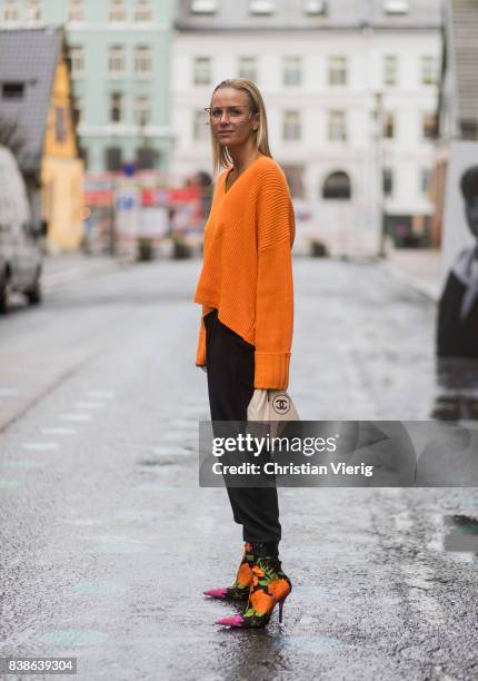 Celine Aagaard wearing an orange knit with zipper on the back, Balenciaga sock boots outside Bik Bok Runway Award on August 24, 2017 in Oslo, Norway.