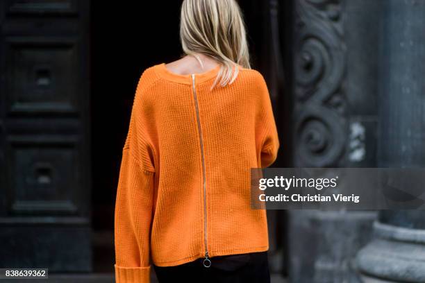 Celine Aagaard wearing an orange knit with zipper on the back outside Bik Bok Runway Award on August 24, 2017 in Oslo, Norway.