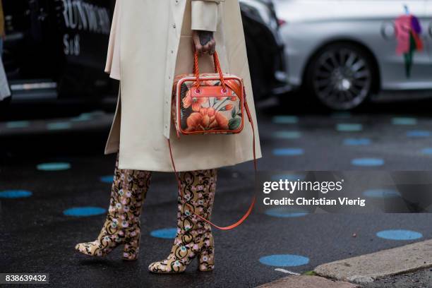 Marianne Theodorsen wearing a trench coat, pastel dress, boots and Balenciaga bag outside Bik Bok Runway Award on August 24, 2017 in Oslo, Norway.