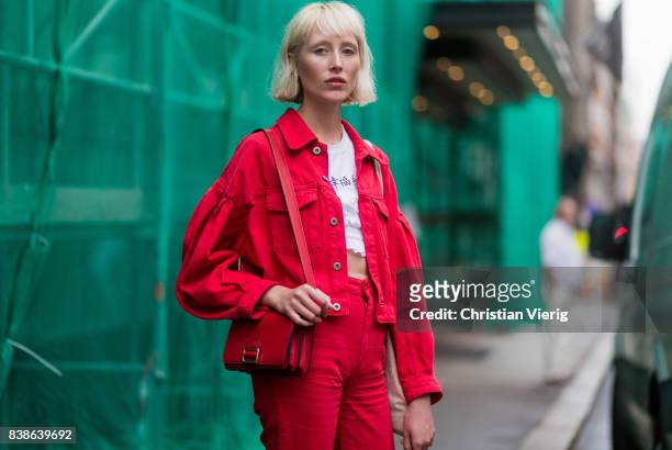 Model wearing red denim jacket, red cropped pants outside Bik Bok Runway Award on August 24, 2017 in Oslo, Norway.