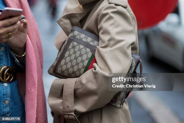 Guest wearing a Gucci bag, trench coat outside Bik Bok Runway Award on August 24, 2017 in Oslo, Norway.