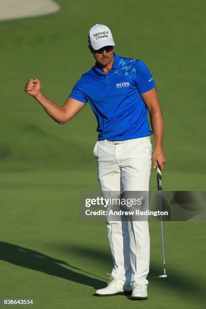 Henrik Stenson of Sweden reacts after putting for birdie on the ninth green during round one of The Northern Trust at Glen Oaks Club on August 24,...