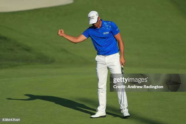 Henrik Stenson of Sweden reacts after putting for birdie on the ninth green during round one of The Northern Trust at Glen Oaks Club on August 24,...
