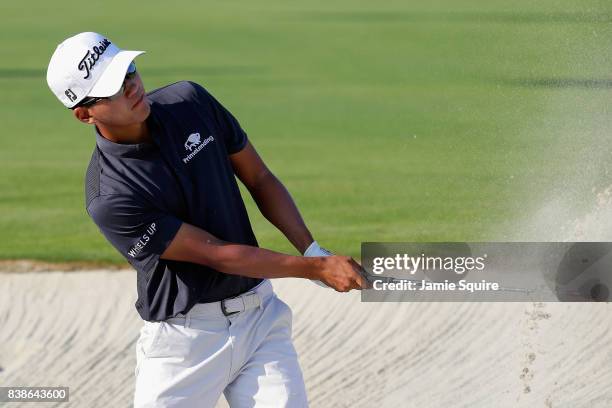 Michael Kim of the United States plays a shot from a bunker on the 17th hole during round one of The Northern Trust at Glen Oaks Club on August 24,...