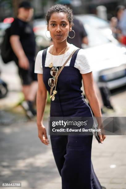 Guest wears a white t-shirt, a blue dress, black shoes, sunglasses, a clutch, outside the Y/Project show, during Paris Fashion Week - Menswear...
