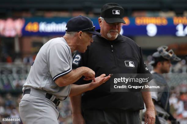 Manager Joe Girardi of the New York Yankees argues with umpire Dana DeMuth in the sixth inning while playing the Detroit Tigers at Comerica Park on...