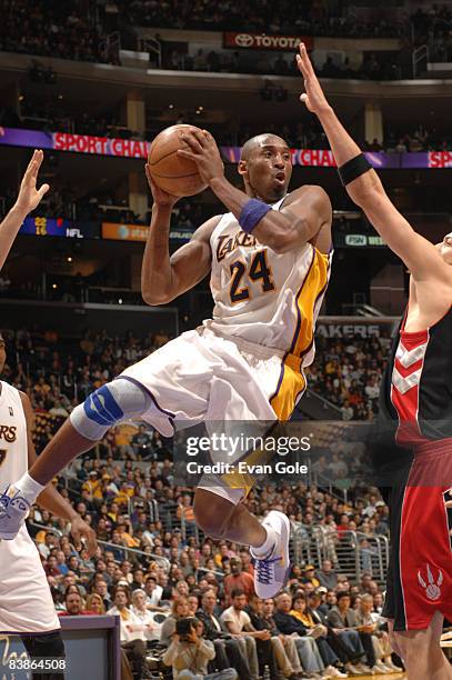 Kobe Bryant of the Los Angeles Lakers jumps to make a pass against the Toronto Raptors during their game at Staples Center on November 30, 2008 in...