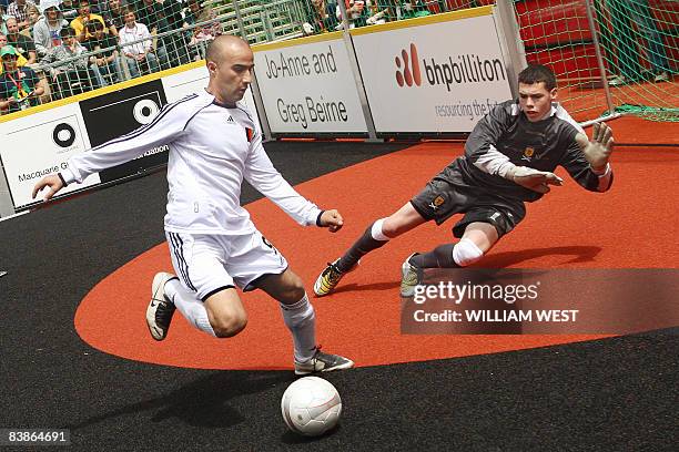 Player from Afghanistan shoots past the Scotland goalkeeper during the opening matches of 2008 Homeless World Cup football tournament being held in...