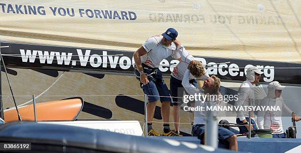 Crew-members of the Ericsson three yatch celebrate after finishing in third place at Port Cochin in Kochi on December 1 in leg two of the Volvo Ocean...