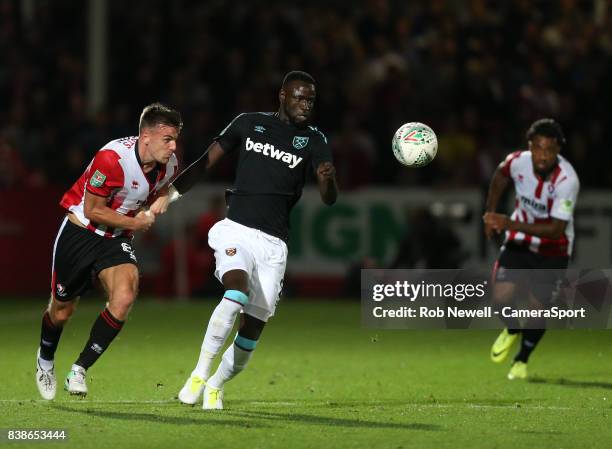 West Ham United's Cheikhou Kouyate and Cheltenham Town's Kevin Dawson during the Carabao Cup Second Round match between Cheltenham Town and West Ham...