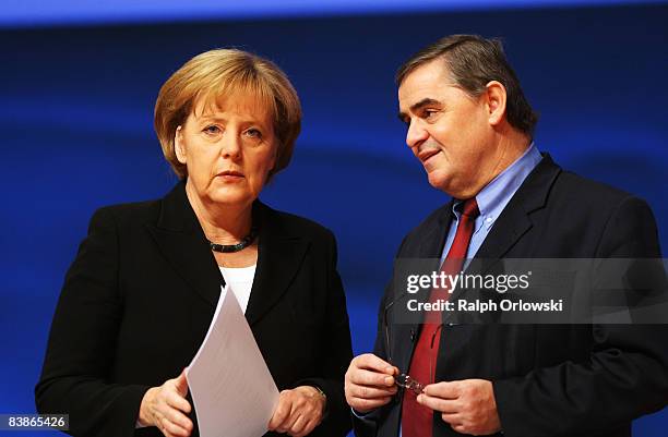 German Chancellor Angela Merkel of the Christian Democratic Union and Peter Mueller, governor of the German state of Saarland, talk at the annual...