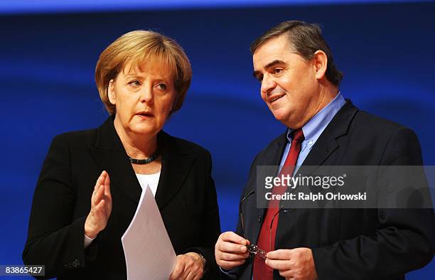 German Chancellor Angela Merkel of the Christian Democratic Union and Peter Mueller, governor of the German state of Saarland, talk at the annual...