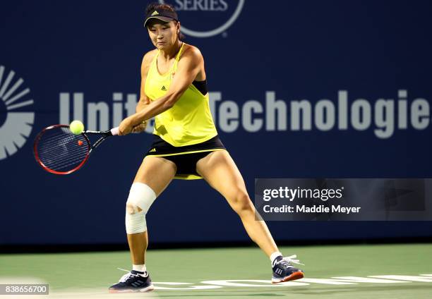 Shuai Peng of China returns a shot to Agnieszka Radwanska of Poland during their match on Day 7 of the Connecticut Open at Connecticut Tennis Center...