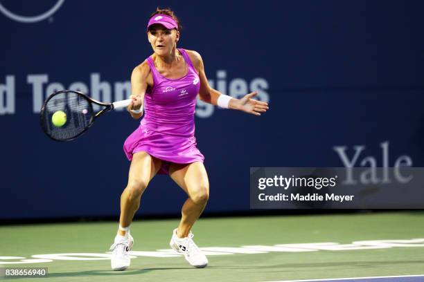 Agnieszka Radwanska of Poland returns a shot to Shuai Peng of China during their match on Day 7 of the Connecticut Open at Connecticut Tennis Center...