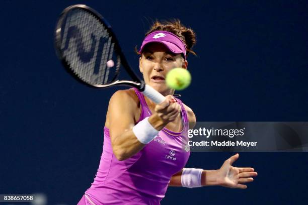 Agnieszka Radwanska of Poland returns a shot to Shuai Peng of China during their match on Day 7 of the Connecticut Open at Connecticut Tennis Center...