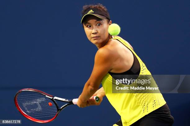 Shuai Peng of China returns a shot to Agnieszka Radwanska of Poland during their match on Day 7 of the Connecticut Open at Connecticut Tennis Center...