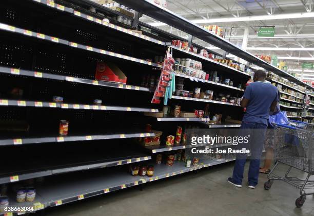 The canned foods section of a Walmart store is almost empty as people prepare for the possible arrival of Hurricane Harvey on August 24, 2017 in...