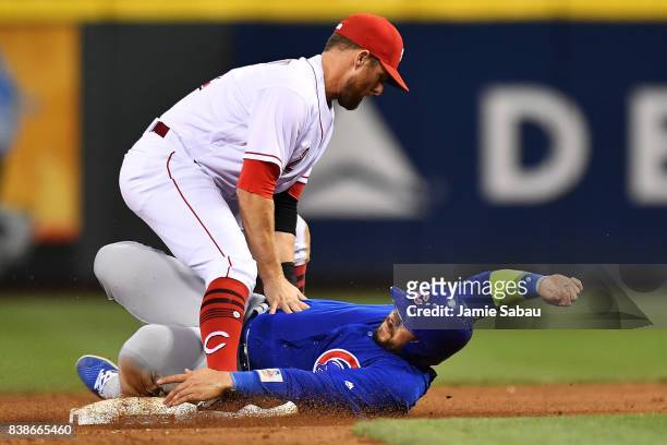 Zack Cozart of the Cincinnati Reds forces out Rene Rivera of the Chicago Cubs at second base to complete a double play in the seventh inning at Great...