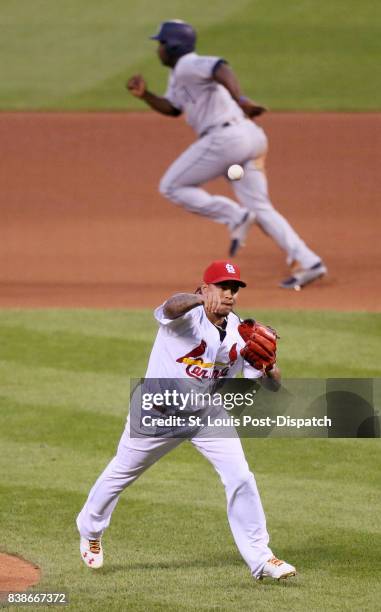 St. Louis Cardinals starting pitcher Carlos Martinez throws high to home plate for an error as the San Diego Padres' Manuel Margot scores and Jose...