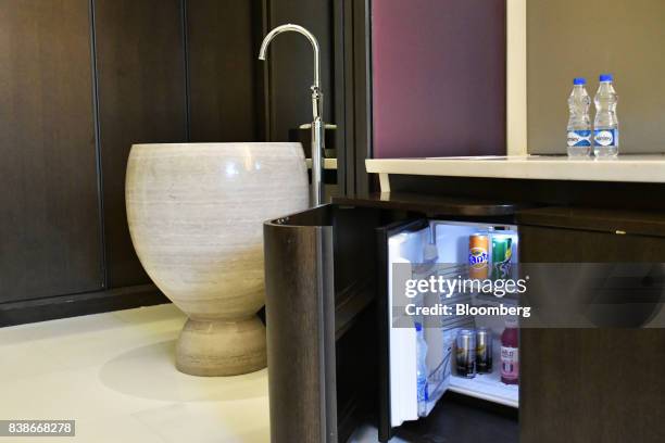 An alcohol-free mini bar is arranged for a photograph inside a guest room of the Roseate New Delhi hotel, operated by the Bird Group, in New Delhi,...