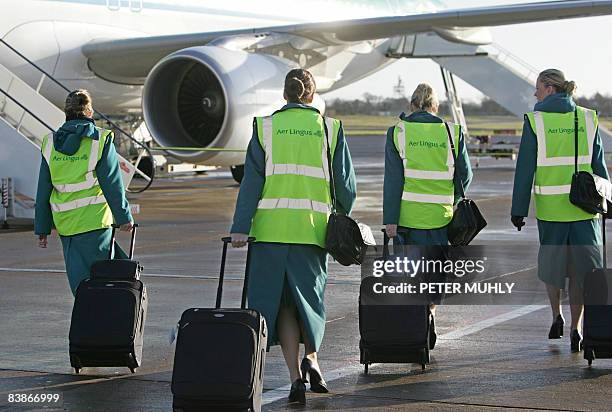 Aer Lingus cabin crew prepare to board an aircraft on the apron at Belfast International Airport in Belfast, Northern Ireland, on December 1, 2008....