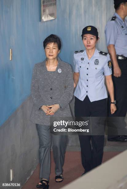 Park Geun-hye, former president of South Korea, left, is escorted by a prison officer as she arrives at the Seoul Central District Court in Seoul,...