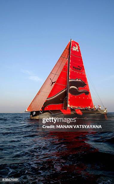 Crew members on the Puma Ocean yatch relax onboard as they finish in fifth place at Port Cochin in Kochi on December 1 in leg two of the Volvo Ocean...