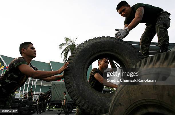 Thai soldiers remove rubber tires near Government House on December 1, 2008 in Bangkok, Thailand. Nearly 100,000 passengers have missed flights since...