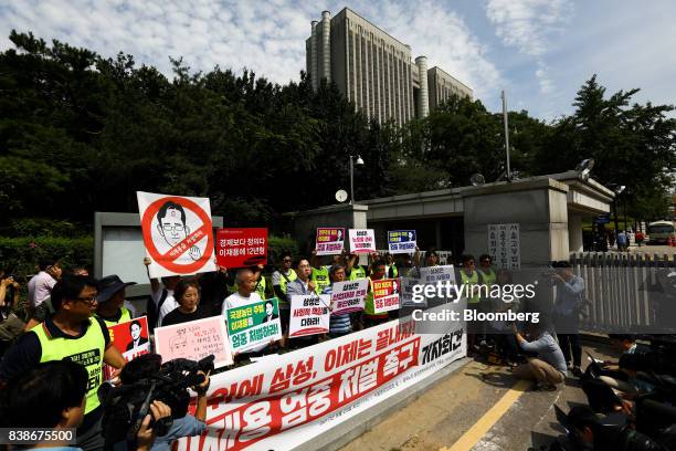 Anti-Samsung protesters hold banners and placards featuring images of Jay Y. Lee, co-vice chairman of Samsung Electronics Co., outside the Seoul...