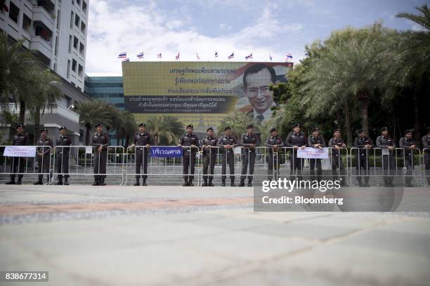 Police officers stand outside the Supreme Court in Bangkok, Thailand, on Friday, Aug. 25, 2017. A Thai court issued an arrest warrant for former...