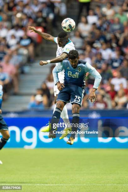 Vancouver Whitecaps midfielder Sheanon Williams and Seattle Sounders defender Nouhou Tolo jump to head the ball during their match at BC Place on...